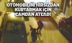 Camdan atlayıp otomobilini hırsızın elinden kurtardı
