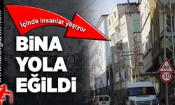 İçinde insanların yaşadığı bina yola doğru eğildi