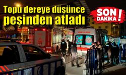 Topu dereye düşünce peşinden atladı