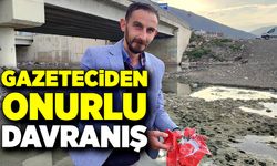 Gazeteci dereye düşen Türk bayrağını çamurun içinden aldı
