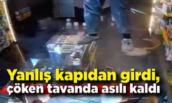 Yanlış kapıdan girdi, çöken tavanda asılı kaldı