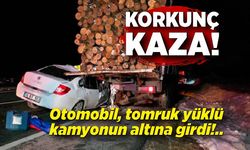 Otomobil, tomruk yüklü kamyonun altına girdi