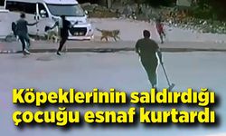 Sokak köpeklerinin saldırdığı çocuğu esnaf kurtardı