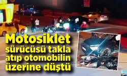 Motosiklet sürücüsü takla atıp otomobilin üzerine düştü