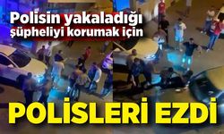 Polisin yakaladığı şüpheliyi korumak için polisleri böyle ezdi