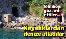Tehlikeyi göz ardı ettiler, kayalıklardan denize atladılar