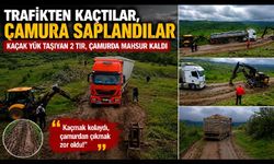 Bayram trafiğinden kaçan tır ve kamyonlar köy yolunda çamura saplandı