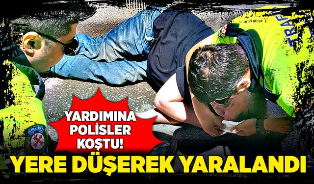 Yere düşerek yaralanan şahsın yardımına polisler koştu